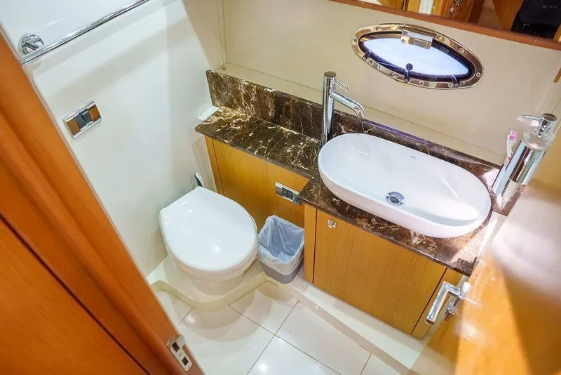 Slide: The Image of Interior view of 2013 Sunseeker Portafino yacht with wooden flooring and sleek dashboard. - 34