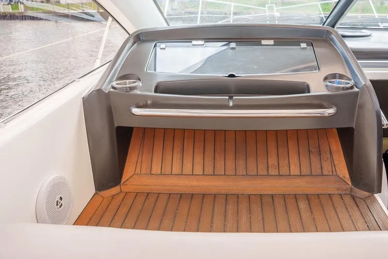 Slide: The Image of 2013 Sunseeker Portafino yacht interior with wooden stairs, TV, and bathroom. - 35