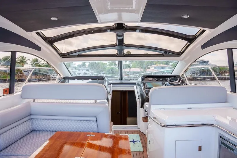 Slide: The Image of Cockpit of 2013 Sunseeker Portafino yacht with navigation screens and steering wheel. - 38
