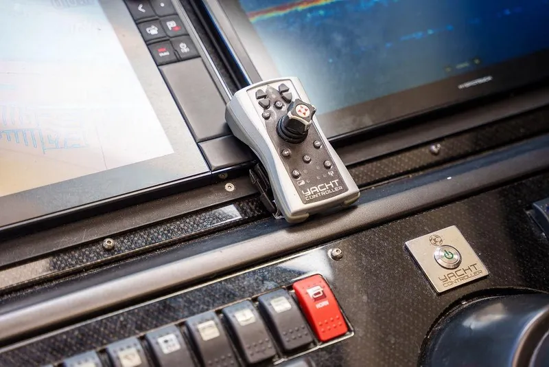 Slide: The Image of 2013 Sunseeker Portafino yacht deck with railing, surrounded by lush greenery and water. - 40