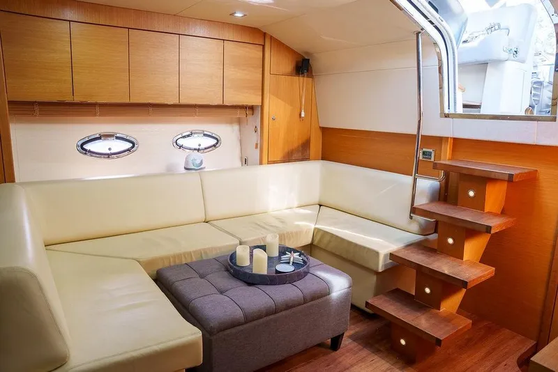 Slide: The Image of 2013 Sunseeker Portafino yacht with radar and antennas, cityscape background. - 45