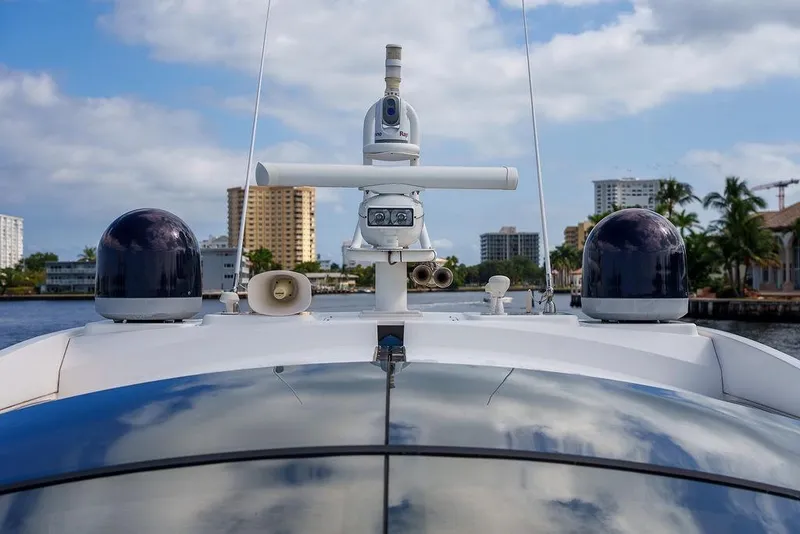 Slide: The Image of 2013 Sunseeker Portafino yacht cruising near waterfront cityscape under blue sky. - 46