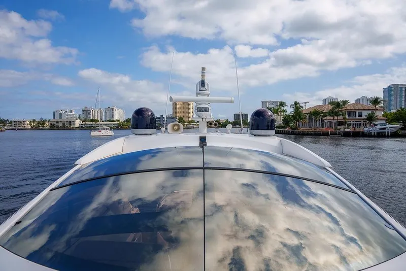 Slide: The Image of 2013 Sunseeker Portafino yacht with sunbathing deck, docked near waterfront buildings. - 47