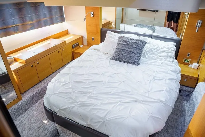 Slide: The Image of Interior of 2013 Sunseeker Portafino yacht, featuring wooden stairs, cozy bedroom, and modern TV. - 61