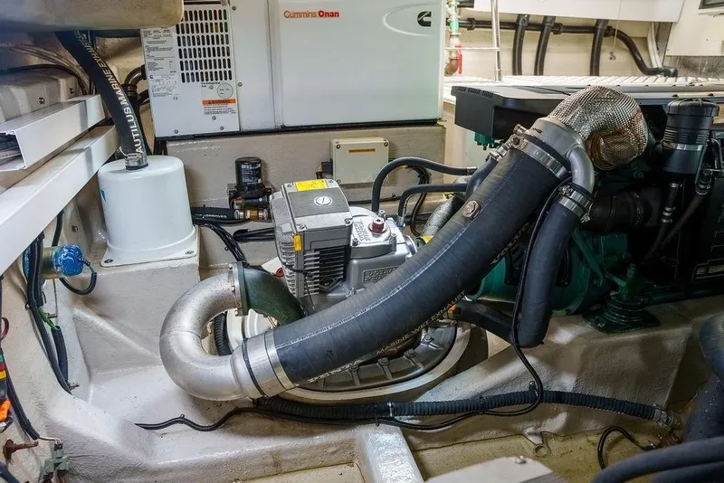 Slide: The Image of Engine room of 2013 Sunseeker Portafino yacht with fire extinguishers and mechanical components. - 72