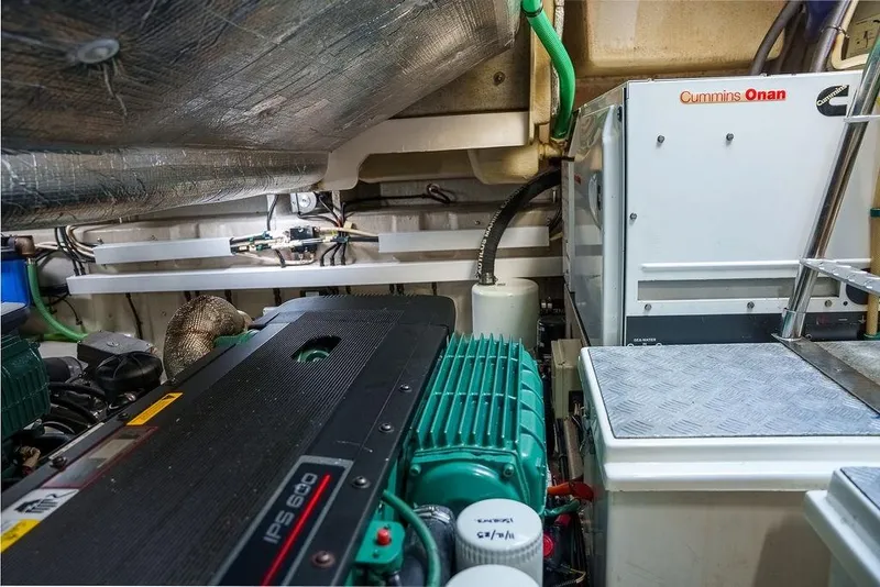 Slide: The Image of Engine room of a 2013 Sunseeker Portafino yacht, showcasing powerful machinery. - 75