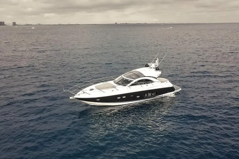 Slide: The Image of 2013 Sunseeker Portafino yacht cruising on open sea under cloudy skies. - 9