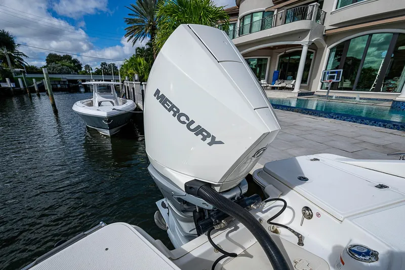 Slide: The Image of 2023 Boston Whaler 250 Dauntless with Mercury engine docked by luxury waterfront home. - 13