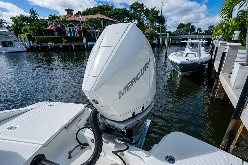 Slide: The Image of 2023 Boston Whaler 250 Dauntless with Mercury engine docked by waterfront homes. - 14