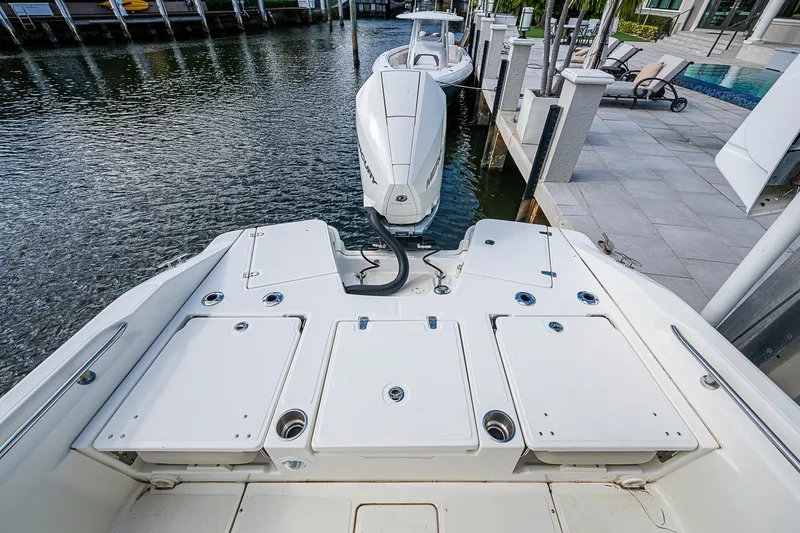 Slide: The Image of 2023 Boston Whaler 250 Dauntless boat docked, showcasing spacious deck and modern design. - 19