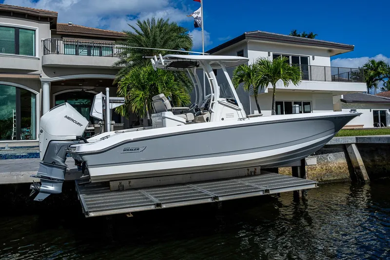 Slide: The Image of 2023 Boston Whaler 250 Dauntless boat docked near luxury waterfront home. - 26
