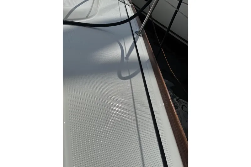 Slide: The Image of Deck of 2004 Beneteau First 36.7 sailboat with textured surface and railing. - 12