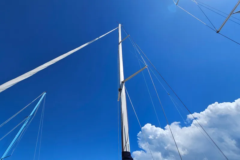 Slide: The Image of Sailboat mast of 2004 Beneteau First 36.7 against clear blue sky and clouds. - 13