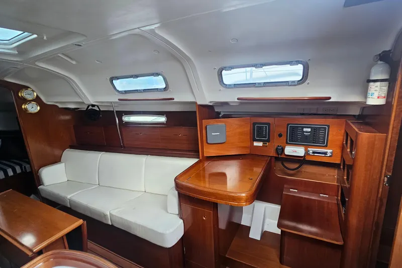 Slide: The Image of Interior of 2004 Beneteau First 36.7 sailboat with wood finish and white seating. - 15