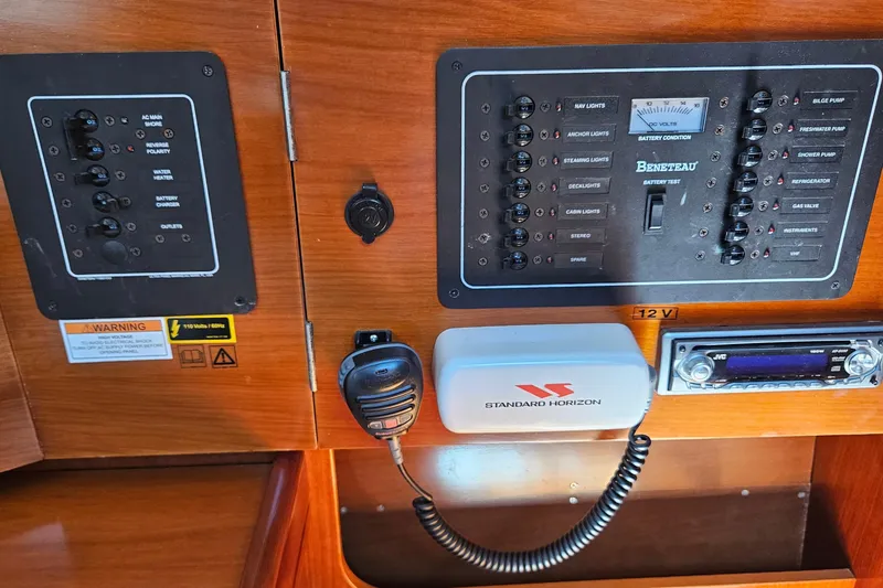 Slide: The Image of Electrical control panel on a 2004 Beneteau First 36.7 sailboat with radio and switches. - 17