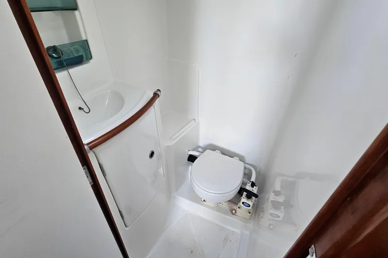 Slide: The Image of Compact bathroom in a 2004 Beneteau First 36.7 sailboat, featuring a toilet and sink. - 21