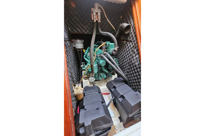 Slide: The Image of Engine compartment of a 2004 Beneteau First 36.7 sailboat, featuring a well-maintained engine. - 24