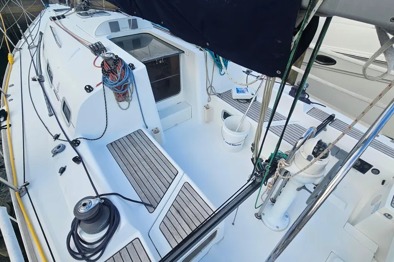 Slide: The Image of 2004 Beneteau First 36.7 sailboat deck with ropes and winches, ready for sailing. - 8