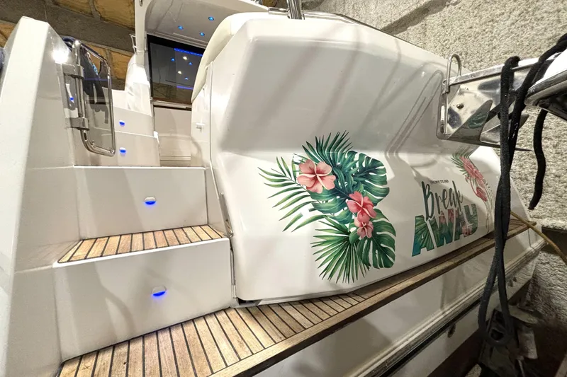 Slide: The Image of 2015 Beneteau Gran Turismo 49 yacht with tropical floral design on the stern. - 14