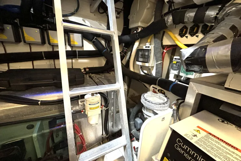 Slide: The Image of Engine room of 2015 Beneteau Gran Turismo 49 yacht, featuring mechanical components and wiring. - 20
