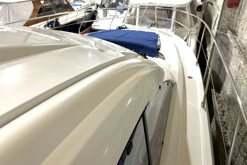 Slide: The Image of 2015 Beneteau Gran Turismo 49 yacht docked, showcasing sleek design and polished exterior. - 25