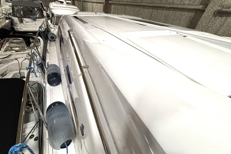 Slide: The Image of 2015 Beneteau Gran Turismo 49 yacht docked in a marina, side view. - 30