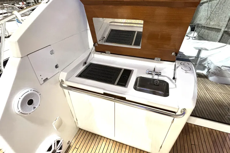 Slide: The Image of Outdoor kitchenette on 2015 Beneteau Gran Turismo 49 yacht with grill and sink. - 32