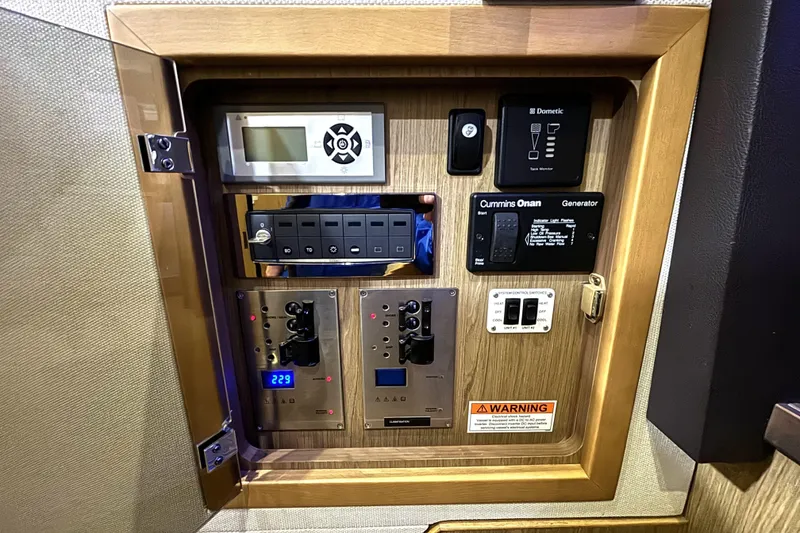 Slide: The Image of Control panel of a 2015 Beneteau Gran Turismo 49 yacht, featuring various switches and displays. - 36