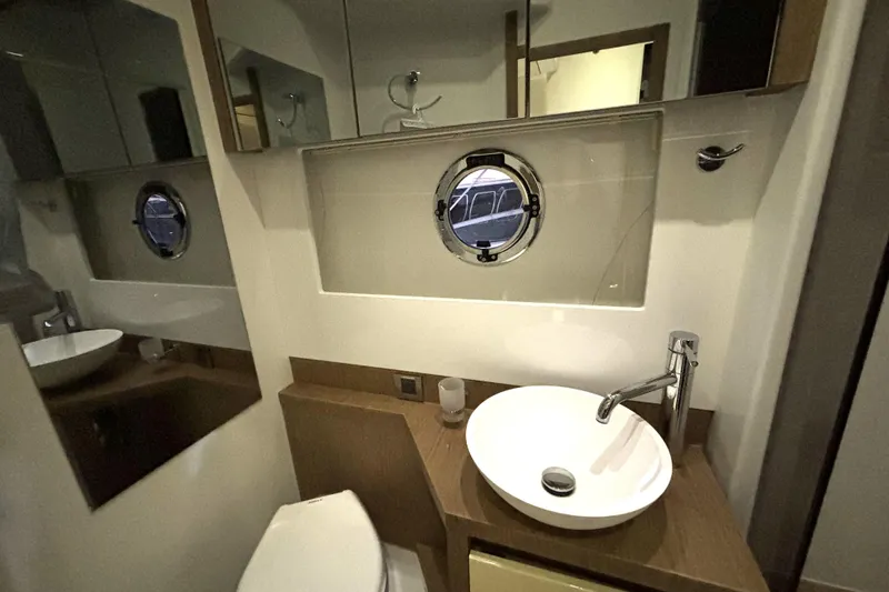 Slide: The Image of Bathroom interior of 2015 Beneteau Gran Turismo 49 yacht with porthole and modern fixtures. - 43