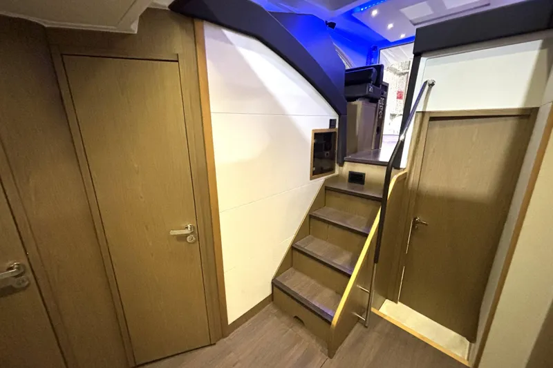 Slide: The Image of Interior of 2015 Beneteau Gran Turismo 49 yacht, featuring wooden stairs and doors. - 51