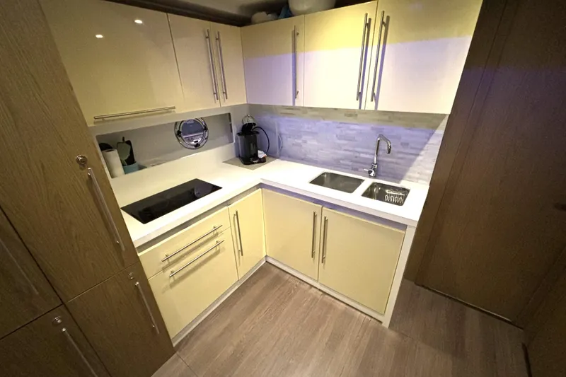 Slide: The Image of Modern kitchen in 2015 Beneteau Gran Turismo 49 yacht with sleek cabinetry and appliances. - 52