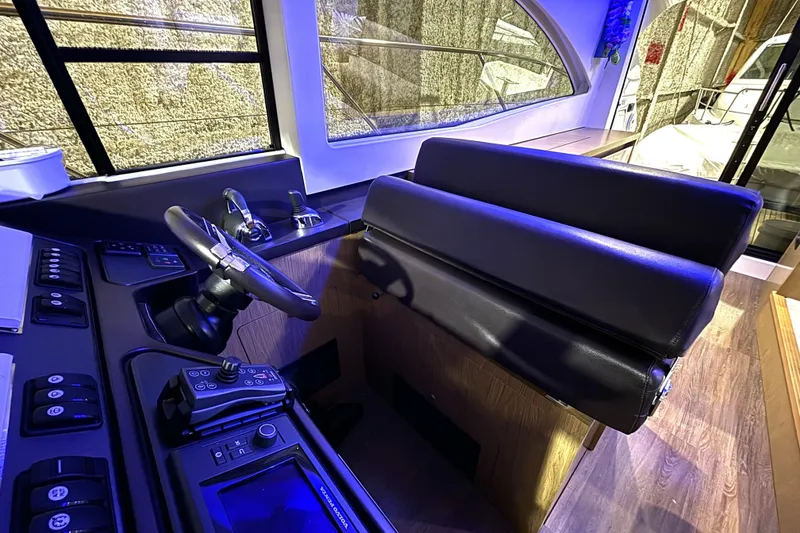 Slide: The Image of Helm station of 2015 Beneteau Gran Turismo 49 with leather seating and modern controls. - 56