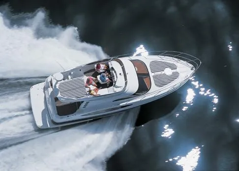 The Image of 2005 Regal Commodore 3880 yacht docked at marina under blue sky. - 0