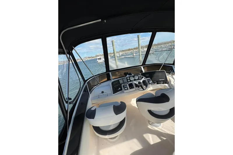 Slide: The Image of 2005 Regal Commodore 3880 boat helm with dual seats and navigation controls. - 10