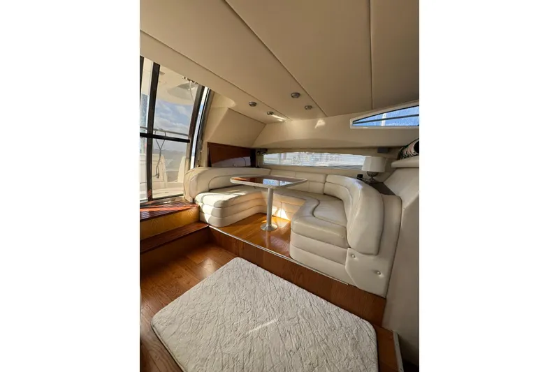 Slide: The Image of Luxurious interior of 2005 Regal Commodore 3880 yacht with plush seating and wooden flooring. - 11