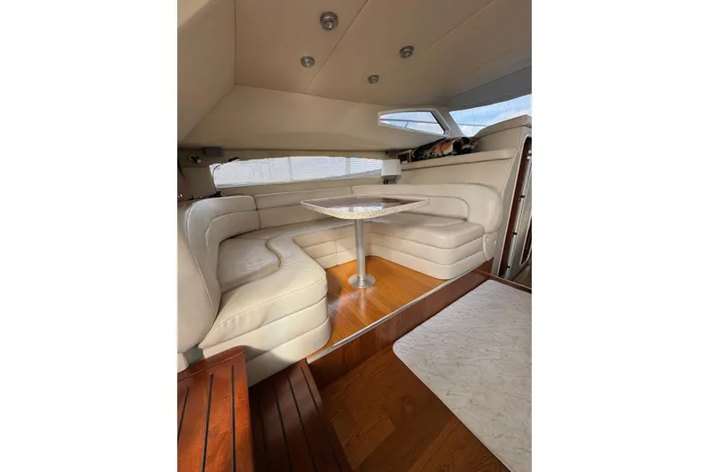 Slide: The Image of Luxurious interior of 2005 Regal Commodore 3880 yacht with plush seating and elegant table. - 12