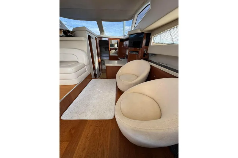 Slide: The Image of Interior of 2005 Regal Commodore 3880 yacht with plush seating and wooden flooring. - 13