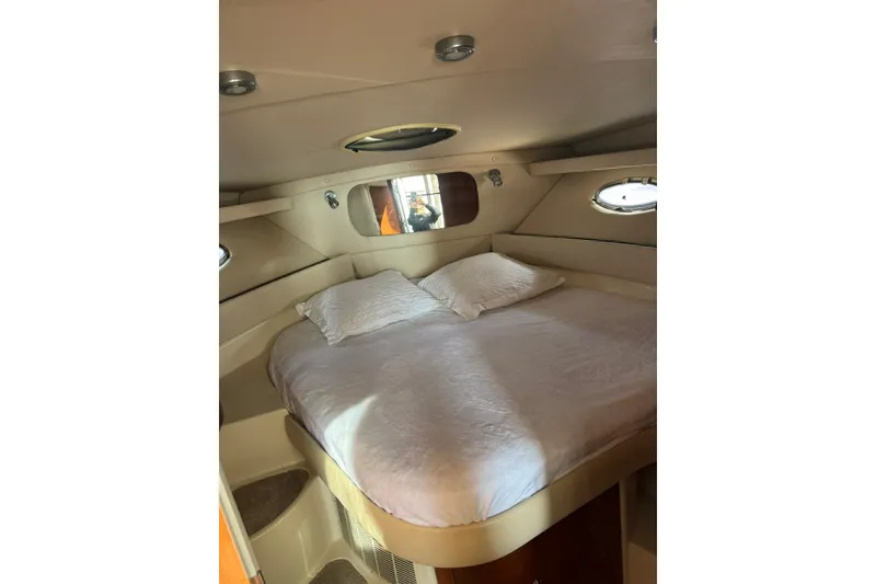 Slide: The Image of Cozy bedroom in 2005 Regal Commodore 3880 yacht with porthole windows and plush bedding. - 16