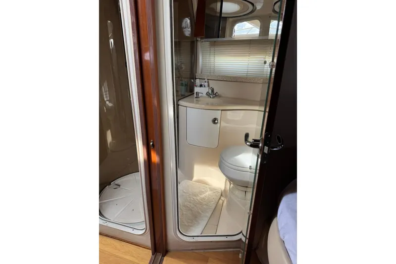 Slide: The Image of Bathroom interior of 2005 Regal Commodore 3880 yacht, featuring sink and toilet. - 19
