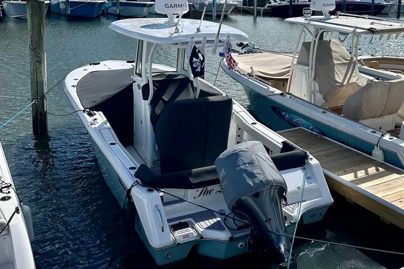 Slide: The Image of 2024 Tidewater 232 LXF boat docked, featuring Yamaha outboard motor and Garmin equipment. - 2