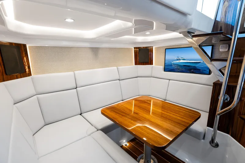 Slide: The Image of Luxurious interior of 2025 HCB 56 Suenos GIX yacht with elegant seating and wooden table. - 18