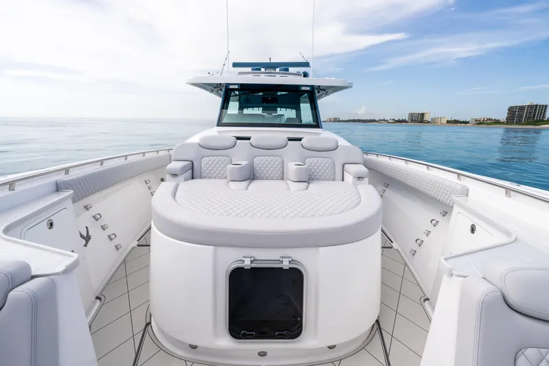 Slide: The Image of 2025 HCB 56 Suenos GIX luxury yacht interior with plush seating on calm waters. - 31