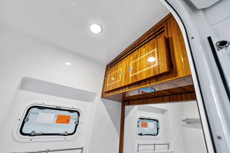 Slide: The Image of Interior of 2025 HCB 56 Suenos GIX boat with wooden cabinets and porthole window. - 36