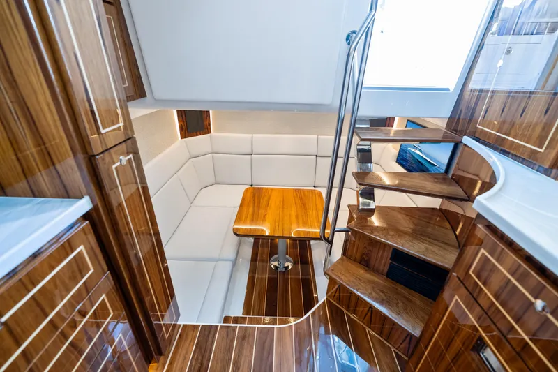 Slide: The Image of Luxurious interior of 2025 HCB 56 Suenos GIX yacht with wooden finishes and seating area. - 51