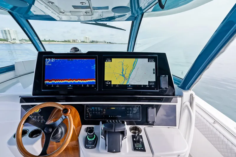 Slide: The Image of Helm of 2025 HCB 56 Suenos GIX with advanced navigation displays and controls. - 53