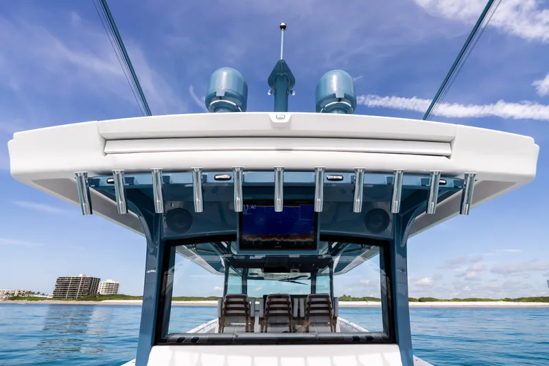 Slide: The Image of 2025 HCB 56 Suenos GIX boat with modern design and ocean backdrop. - 60