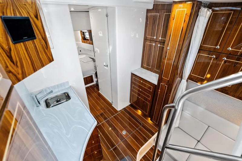 Slide: The Image of Luxurious interior of 2025 HCB 56 Suenos GIX yacht with wood finishes and modern amenities. - 12
