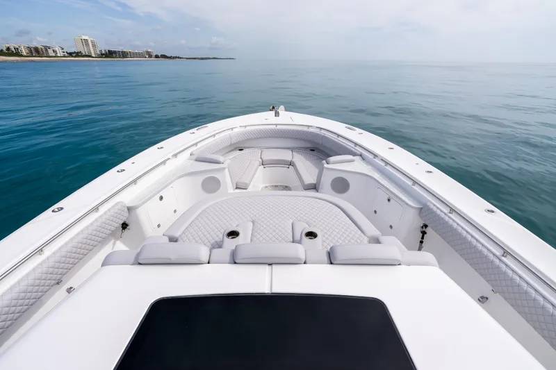 Slide: The Image of 2025 HCB 56 Suenos GIX luxury boat with spacious seating on calm ocean waters. - 15
