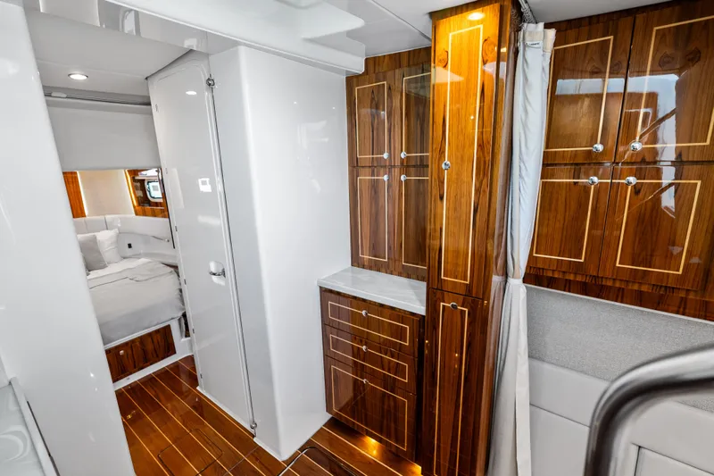 Slide: The Image of Luxurious interior of 2025 HCB 56 Suenos GIX yacht with elegant wood cabinetry. - 26