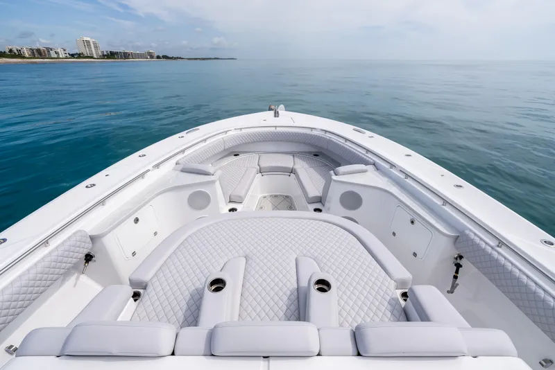 Slide: The Image of 2025 HCB 56 Suenos GIX luxury yacht interior with plush seating on calm ocean. - 3